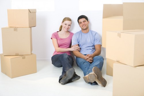 Packed boxes and furniture being loaded into a moving van
