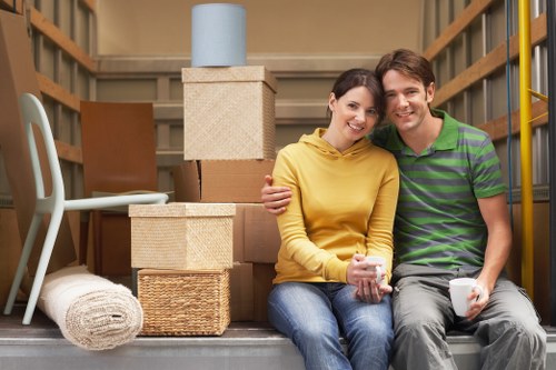 Movers carrying furniture through a stairwell in an Earlscourt property